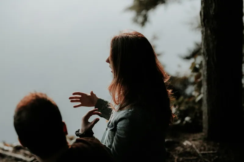 Two people in conversation outdoors